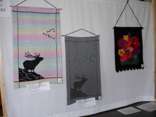 Two wall hangings by Jill Lothian and one by Frances Murray